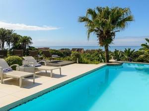 a swimming pool with a view of the ocean at 11 On Fairway Villa by Euphoric Leisure in Southbroom