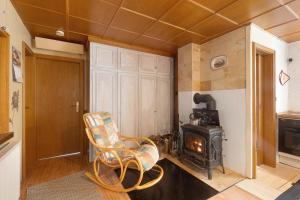 a living room with a chair and a wood stove at Haus am See in Gedern