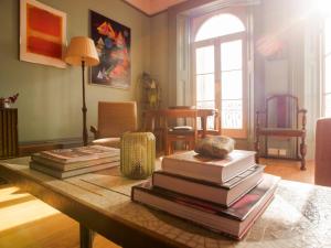 a stack of books on a table in a living room at Beautiful sea front apartment with balcony in St Leonards-on-Sea in Hollington