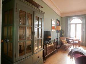 a living room with a hutch with glass doors at Beautiful sea front apartment with balcony in St Leonards-on-Sea in Hollington