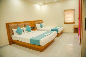 a bedroom with two beds in a room at Marine Grand Suite in Cochin