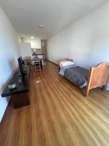 a bedroom with a bed and a desk and a table at Depto 3 de Febrero 235 in Venado Tuerto