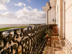 a balcony of a building with a view of the ocean at Beautiful sea front apartment with balcony in St Leonards-on-Sea in Hollington