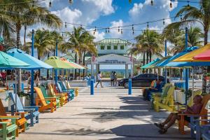 a street with chairs and umbrellas on a beach at Ocean Reef Hotel in Fort Lauderdale