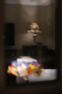 a blurry picture of a table with a lamp and a plate at Beijing Xiaofengxian Former Residence Hotel Tiananmen Square Qianmen Store in Beijing