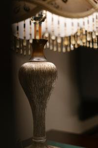a vase sitting on a table in front of a mirror at Beijing Xiaofengxian Former Residence Hotel Tiananmen Square Qianmen Store in Beijing