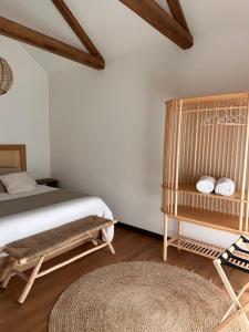 a bedroom with a bed and a table and a rug at Balarés Hotel da Natureza in Ponteceso