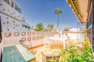 a patio with a table and chairs on a balcony at The lighthouse horizon in Las Lagunas Mijas