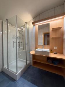 a bathroom with a shower and a sink at Landhaus Volderau in Neustift im Stubaital +23 photos