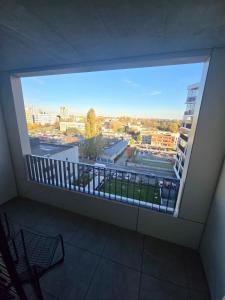 a balcony with a view of a city at Emma's Appartment with Free Parking in Nivy