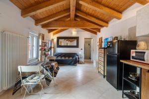 a kitchen and living room with a black refrigerator at Maison Nature e Relax Rubino in Osiglia