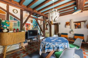 a living room with a table and chairs at La Closerie du Cassereau in Vernou-sur-Brenne
