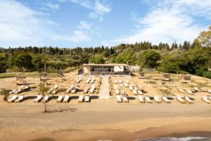 a group of lounge chairs on a beach at Ayla Corfu in Kavos