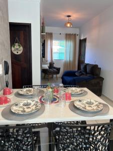Una mesa con platos encima en una sala de estar. en Iririu 01 · Ap térreo a 2 km - Hospital Regional Hans Dieter, en Boa Vista