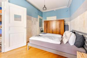 a bedroom with a bed with a wooden headboard at Historic Gem - Lift - Balcony in Basel +32 photos