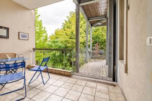 a patio with chairs and a table on a porch at Historic Gem - Lift - Balcony in Basel