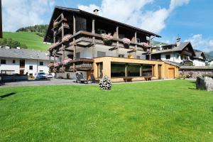 a large house with a lawn in front of it at Hotel Residence Olympia Sarntal in Sarntal
