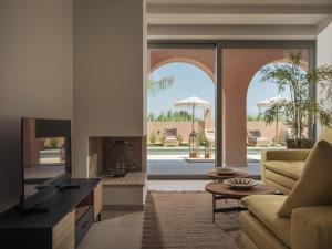 a living room with a couch and a fireplace at Sol in Amoudi