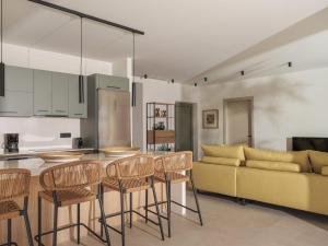 a kitchen and living room with a table and chairs at Sol in Amoudi