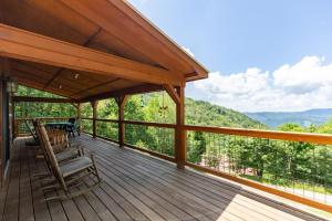a wooden deck with chairs and a table on it at Silverleaf in Zionville