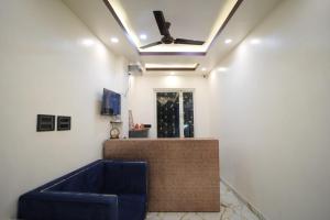 a living room with a blue couch and a ceiling at Om Palace Inn in Varanasi