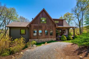 a home in the woods with a gravel driveway at Owls Nest in Seven Devils