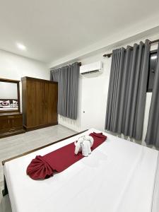 a teddy bear sitting on a bed in a room at Dewliya Rest in Galle
