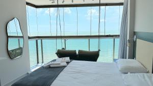 a bedroom with a bed with a view of the ocean at Diamond Beach in Vila Velha +268 photos