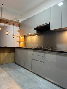 a large kitchen with white cabinets and appliances at Dewliya Rest in Galle