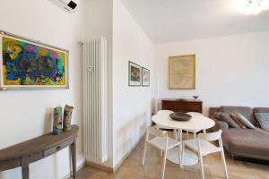 a living room with a table and a couch at Attico Center with View and Terrace in Desenzano del Garda