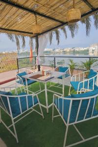 a table and chairs with a view of the water at Bp lake view in Udaipur