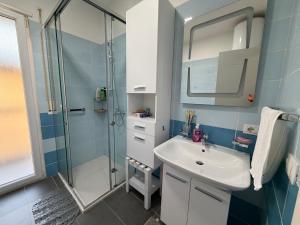 a bathroom with a sink and a shower at Riva'S Apartament in Shkodër +12 photos
