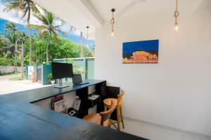 a room with a desk and a computer on a wall at Teya Beach Hotel in Ahangama