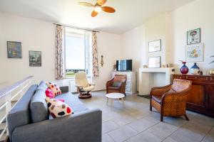 a living room with a couch and chairs and a fireplace at Gîte des Fours à Chaux in Saumur