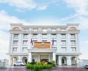 a large white building with a sign on it at Hotel Roma Kristo in Dwarka