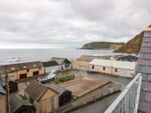 an aerial view of a town with the ocean at The Old Kipper Hoose in Gardenstown