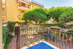 Un balcón de un edificio con plantas y una valla. en Casa Musa Giardini Naxos, en Giardini Naxos