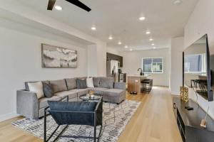 a living room with a couch and a table at 3 Min to DT 2 Car Garage Lux Townhome King Bed in Salt Lake City