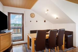 a dining room with a table and chairs and a window at Ferienwohnung 'Haus Blütenmeer' in Langenargen