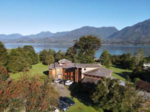 an aerial view of a house next to a lake at Andes Lodge, Puelo Patagonia in Puelo