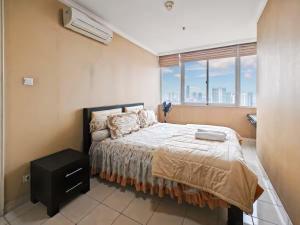 a bedroom with a bed and a large window at Newly Large 2BR Ambassador2 Apt with Pool Gym WiFi in Jakarta +40 photos