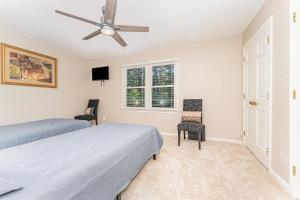 a bedroom with two beds and a ceiling fan at Haven House-10 Min From PTI in Greensboro +13 photos