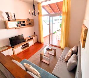 a living room with a couch and a tv at Casa Cofete in Morro del Jable