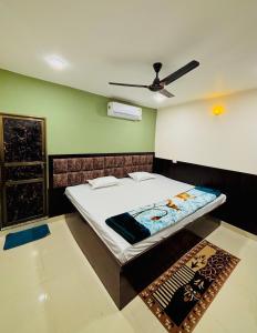 a bedroom with a bed and a ceiling fan at Shree Balaji Comfort in Varanasi