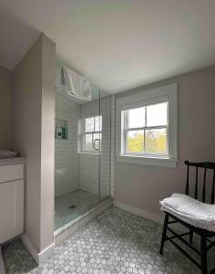 a large bathroom with a shower with a window at Tranquility Near Hudson & The Berkshires in Chatham +38 photos
