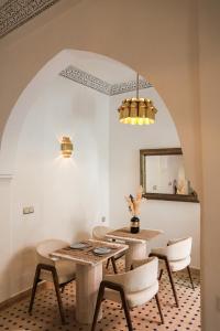 a dining room with a table and chairs at Riad Olma in Marrakech