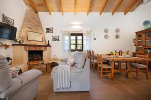 a living room with a table and a dining room at Finca Cati Ref 57 in Son Servera