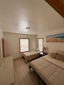 a bedroom with two beds and a painting on the wall at Cozy 2BR Basement Apartment with Private Entry & Parking in Elizabeth, NJ in Elizabeth