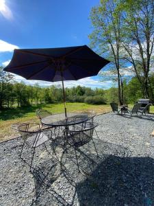 a table with an umbrella on top of it at Tranquility Near Hudson & The Berkshires in Chatham