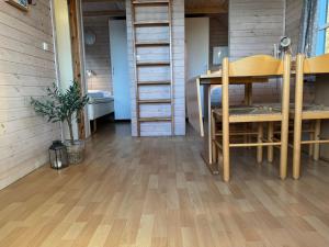 a room with a table and chairs and a wooden floor at Vedersø Strand Camping in Ulfborg